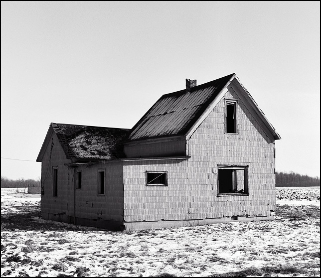 abandoned farm house in huntington county, indiana near interstate 69 in winter with snow on the ground. county road 900s.