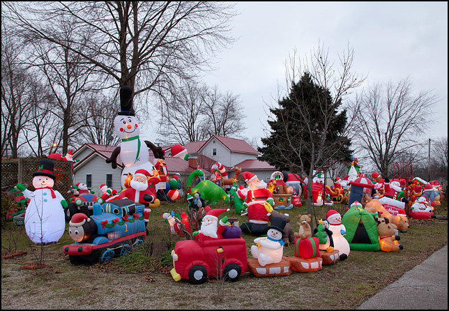 Inflatable Christmas decorations completely fill the yard of a house in the small town of Wolf Lake, Indiana.